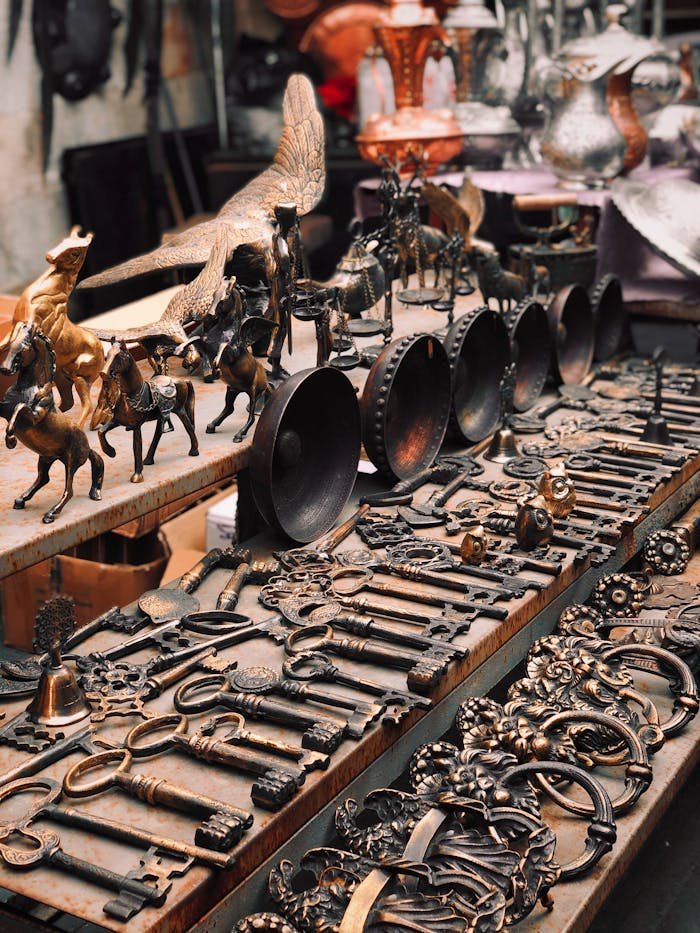 Close-up of vintage metal crafts displayed at a bazaar, showcasing intricate designs and artistry.